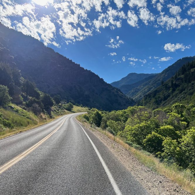 Blacksmith Fork Canyon, Utah. Blue skies with open road leading into the mountains.