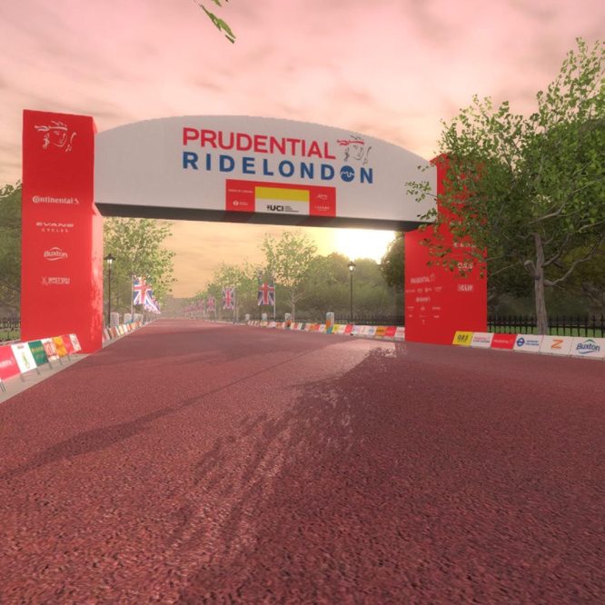 A virtual image of the Prudential RideLondon event in Zwift, featuring a wide race course with a red finish arch. The path is lined with banners and trees, under a sunset sky.