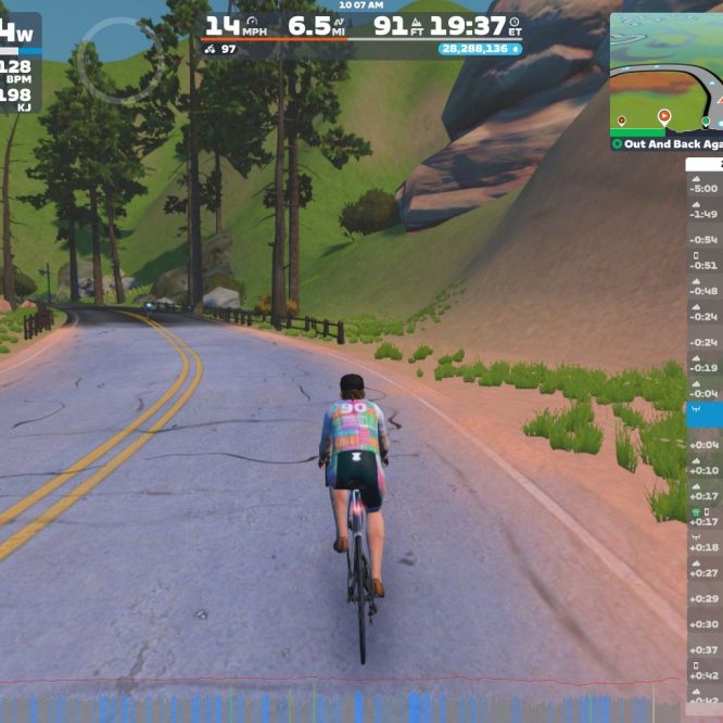 A cyclist rides along a winding road surrounded by green hills and trees in a virtual environment. The cyclist's performance metrics, including power output, speed, and heart rate, are displayed on the screen, along with a map and a list of nearby cyclists.