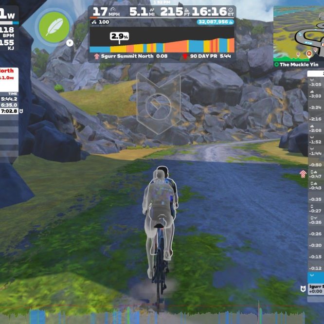 A virtual cycling screen displaying performance metrics. A cyclist is riding on a path surrounded by rocks and greenery in the Zwift environment. The interface shows power output, speed, distance, heart rate, and rankings for different segments, including recent performance records. A map and list of nearby users are also visible.