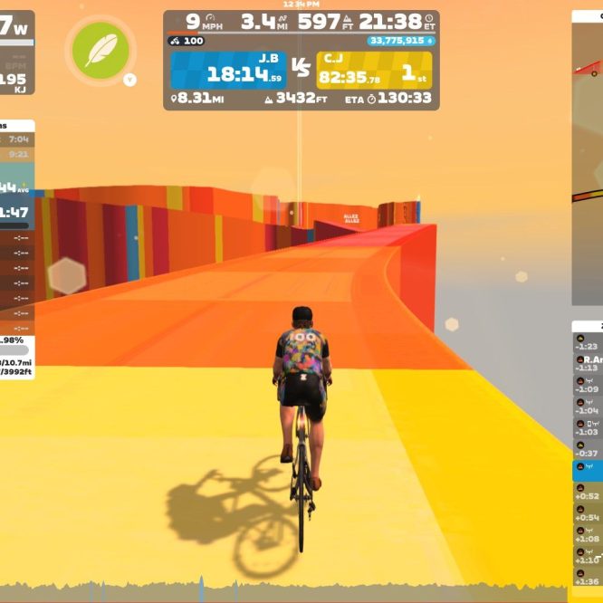A cyclist is riding on a colorful, elevated pathway in the virtual environment of Zwift. The background features bright colors and a gradient sky. The screen displays various performance metrics such as power output, speed, and distance traveled, along with rankings of nearby riders.