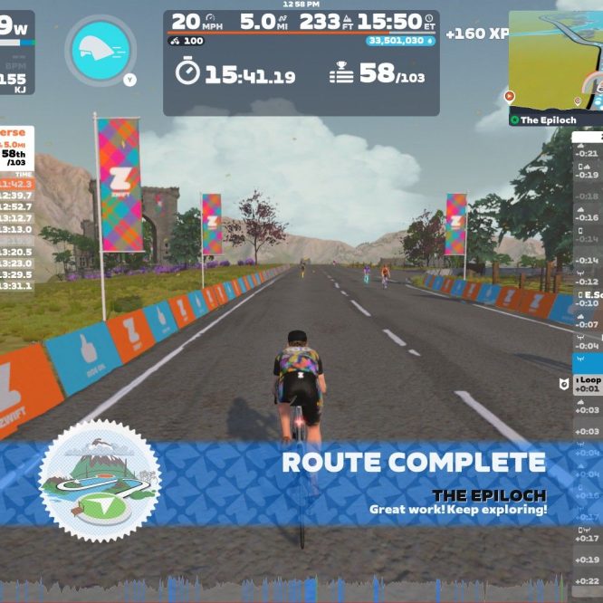 A cyclist is riding on a virtual road in Zwift, celebrating the completion of the "Loch Loop Reverse" route. The screen displays performance metrics, a list of competitors' rankings and times, and colorful banners along the road. A message at the bottom congratulates the rider and encourages further exploration.